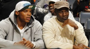 The two largest personalities in Charlotte and Cam in a Charlotte Hornets hat at a Bobcats game before the announcement